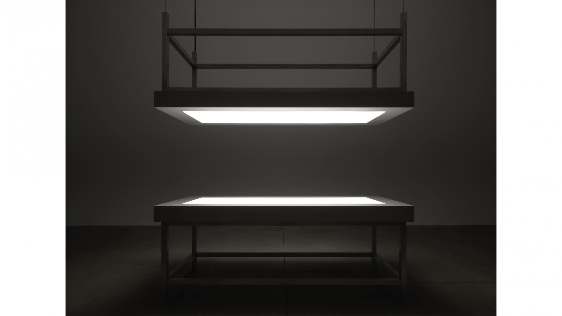 Alfredo Jaar, "Lament of the images" 2002Two aluminum tables, glass, perspex, LED lights and motor420 × 244 ×122 cm